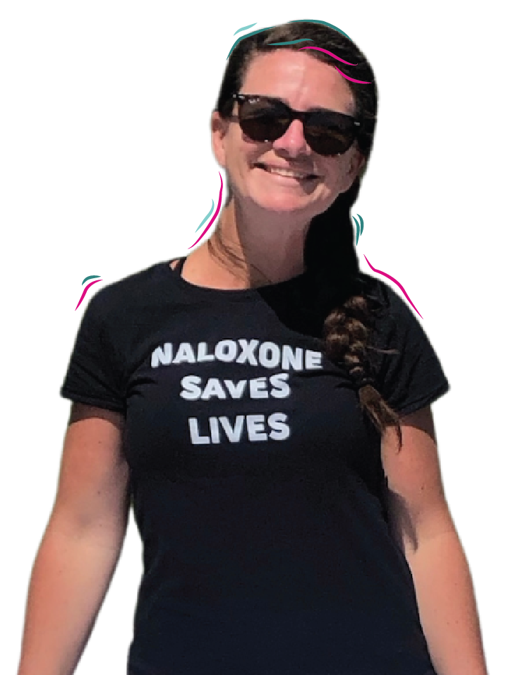 portrait of an OPTIONS Liaison - smiling white woman with hair in a braid wears sunglasses and a black t-shirt with the slogan "naloxone saves lives"